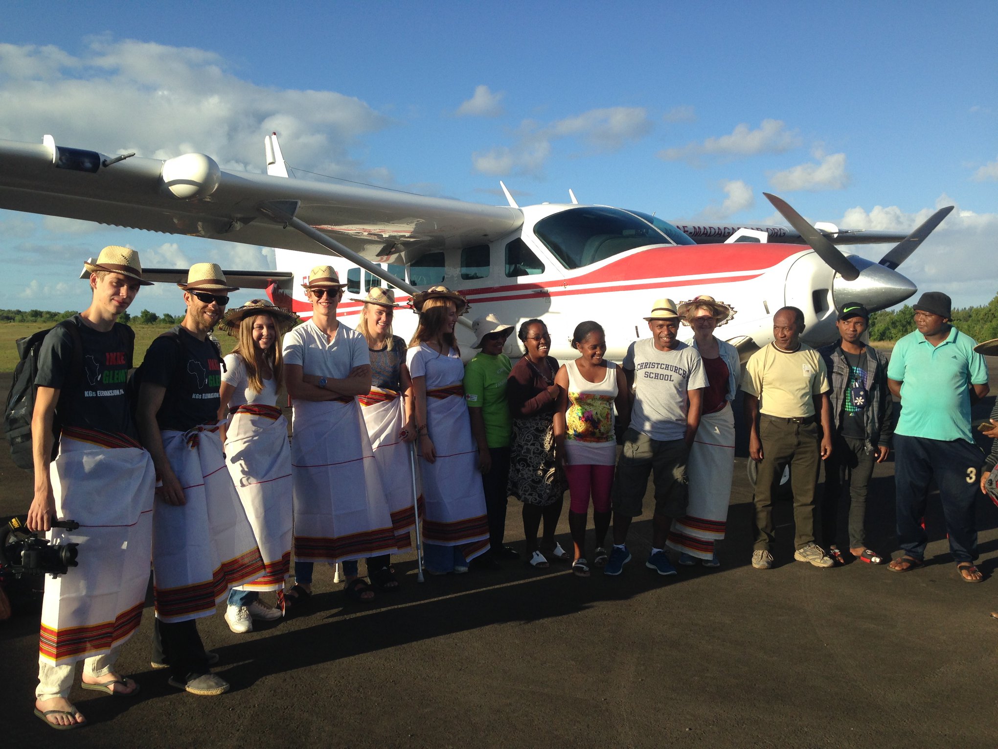 Guests with local community at airstrip